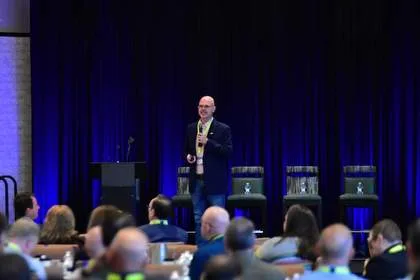Speaker addressing full-room audience at Tech Valley Cybersecurity Symposium